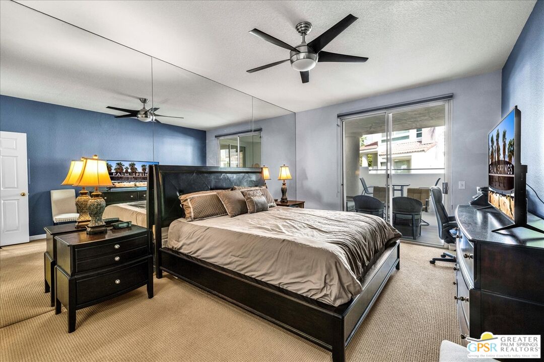 401 El Cielo Road, Unit 147 Palm Springs, CA 92262 - Photo 14 of 44 a bedroom with a bed and a flat screen tv