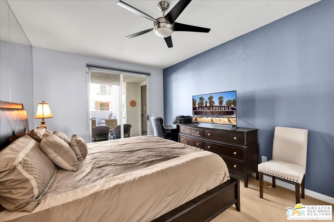 401 El Cielo Road, Unit 147 Palm Springs, CA 92262 - Photo 15 of 44 a bedroom with a bed and a chair