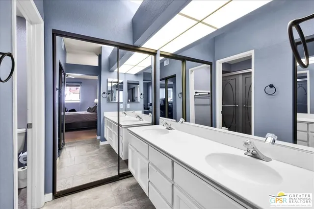 a en suite bathroom with a sink and a mirror