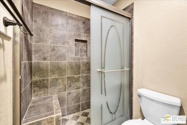a bathroom with a toilet and a shower