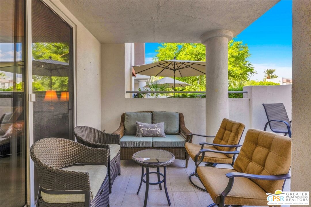 401 El Cielo Road, Unit 147 Palm Springs, CA 92262 - Photo 24 of 44 a living room with furniture and a floor to ceiling window