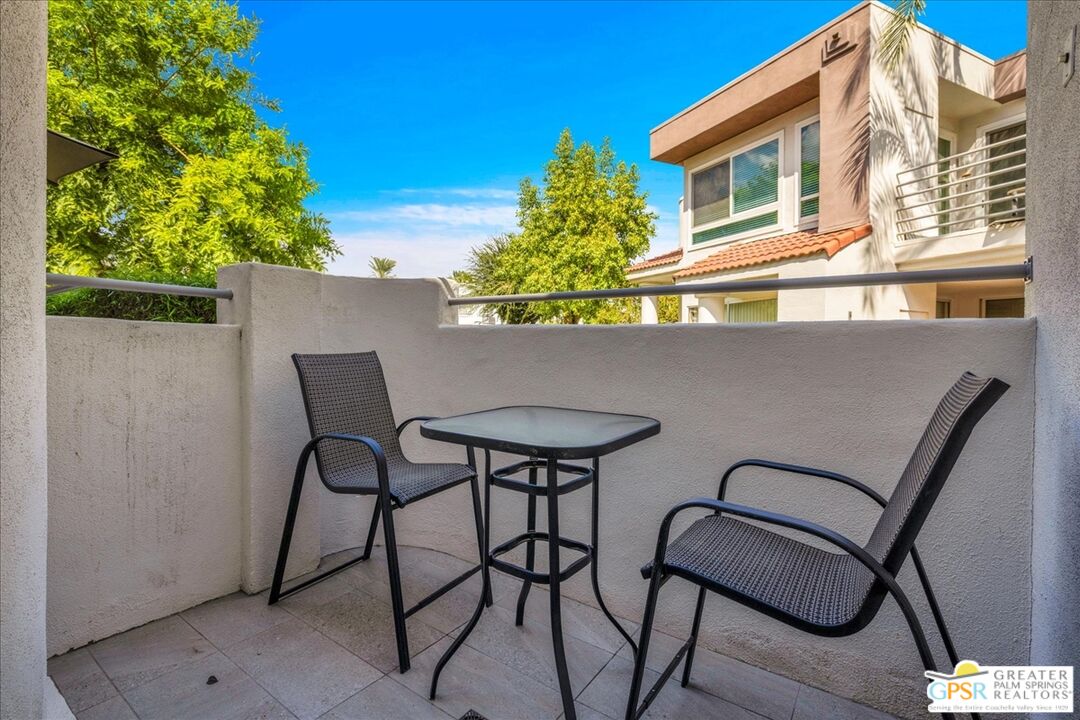 401 El Cielo Road, Unit 147 Palm Springs, CA 92262 - Photo 28 of 44 a backyard of a house with table and chairs