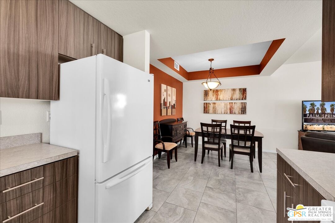 401 El Cielo Road, Unit 147 Palm Springs, CA 92262 - Photo 3 of 44 a view of a kitchen with dining area a sink and a refrigerator