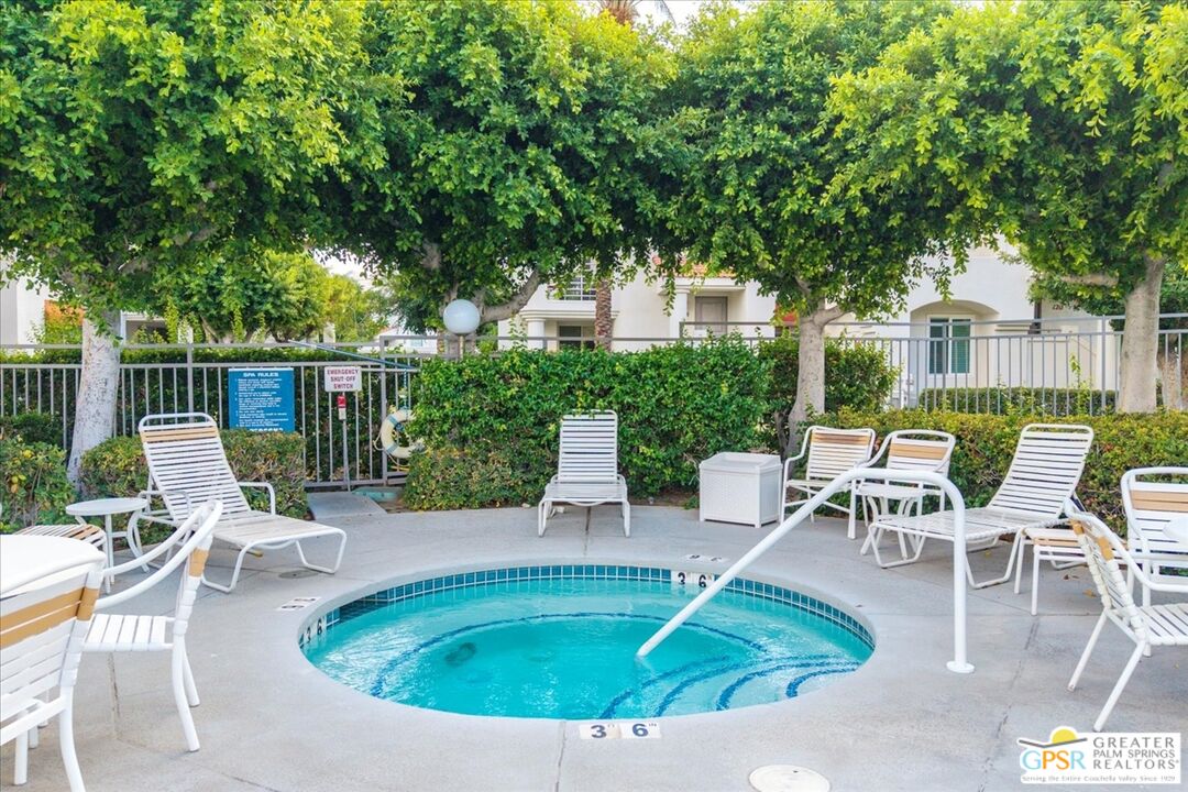 401 El Cielo Road, Unit 147 Palm Springs, CA 92262 - Photo 34 of 44 a swimming pool with outdoor seating and yard