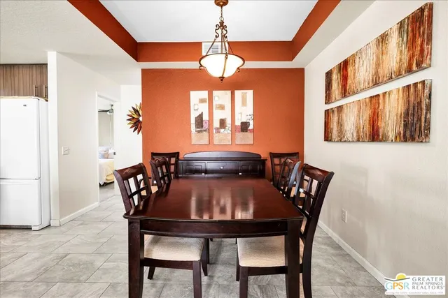 a view of a dining room with furniture and window