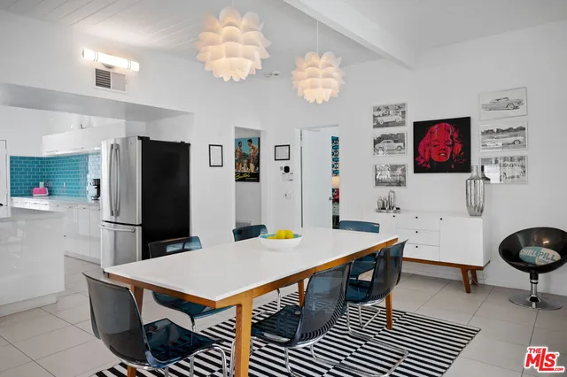 a room with furniture a chandelier and a dining table