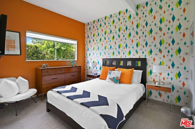 a bedroom with a bed and window