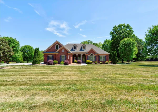a front view of a house with a big yard