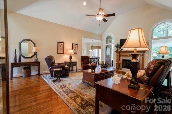 a living room with fireplace furniture and a large window
