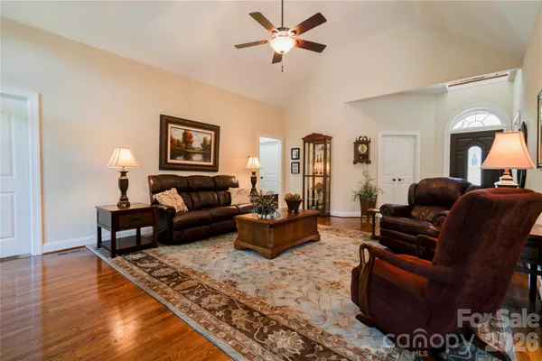 a living room with furniture ceiling fan and a rug