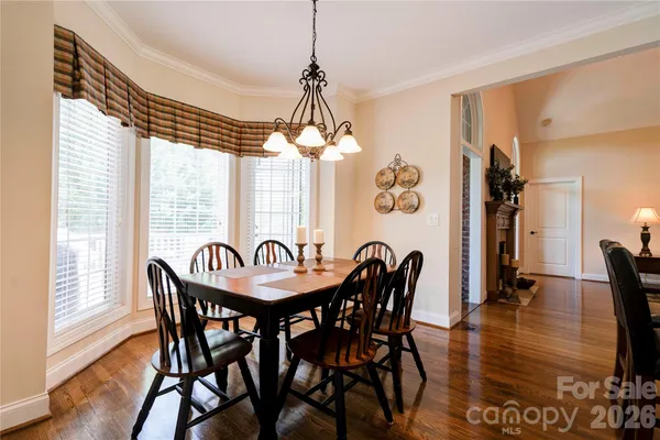 a dining room with furniture window and wooden floor