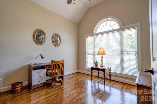 a view of a livingroom with furniture wooden floor and a window