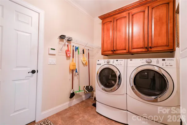 a view of a bedroom with washer and dryer