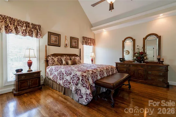a bedroom with a bed and a dresser next to a window