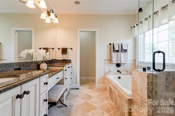 a bathroom with double sink and a mirror