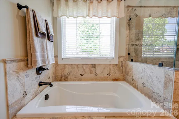 a bathroom with a bathtub and shower