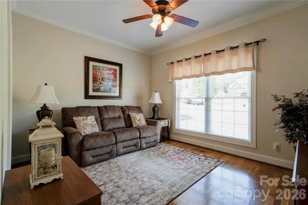 a bedroom with furniture and a flat screen tv