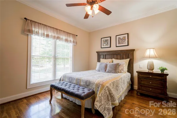 a bedroom with a bed and painting on the wall