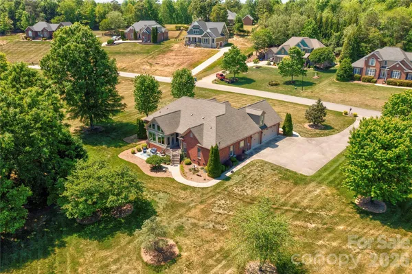 an aerial view of a house with yard swimming pool and outdoor seating