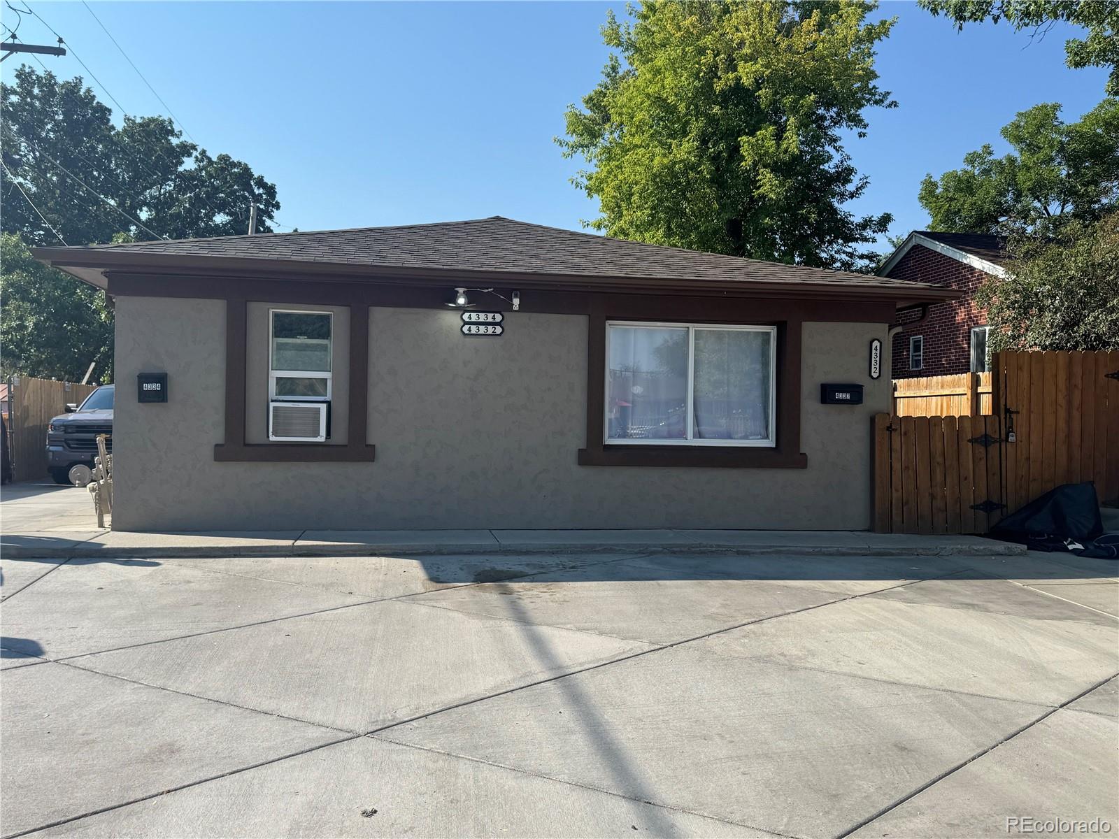 4332 West Nevada Place Denver, CO 80219 - Photo 2 of 14 a front view of a house with a garage