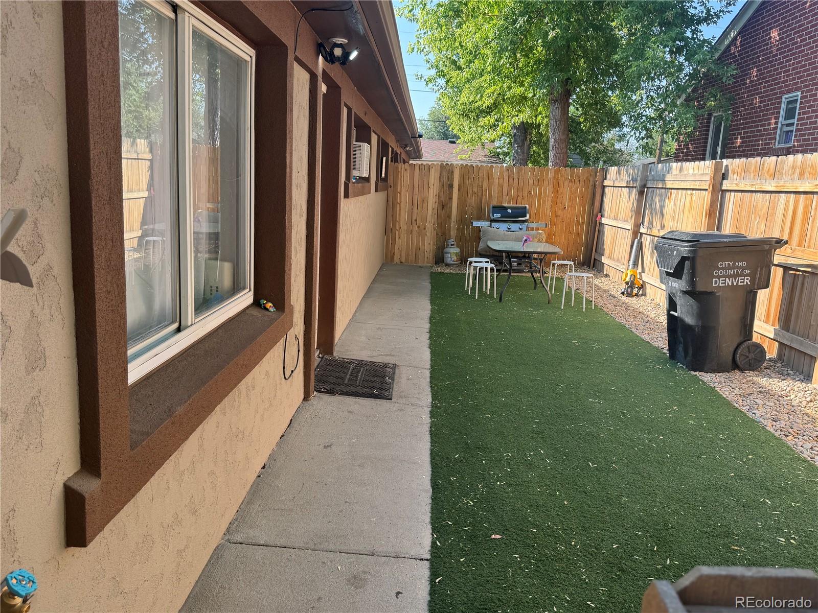 4332 West Nevada Place Denver, CO 80219 - Photo 3 of 14 a porch with a table and chairs
