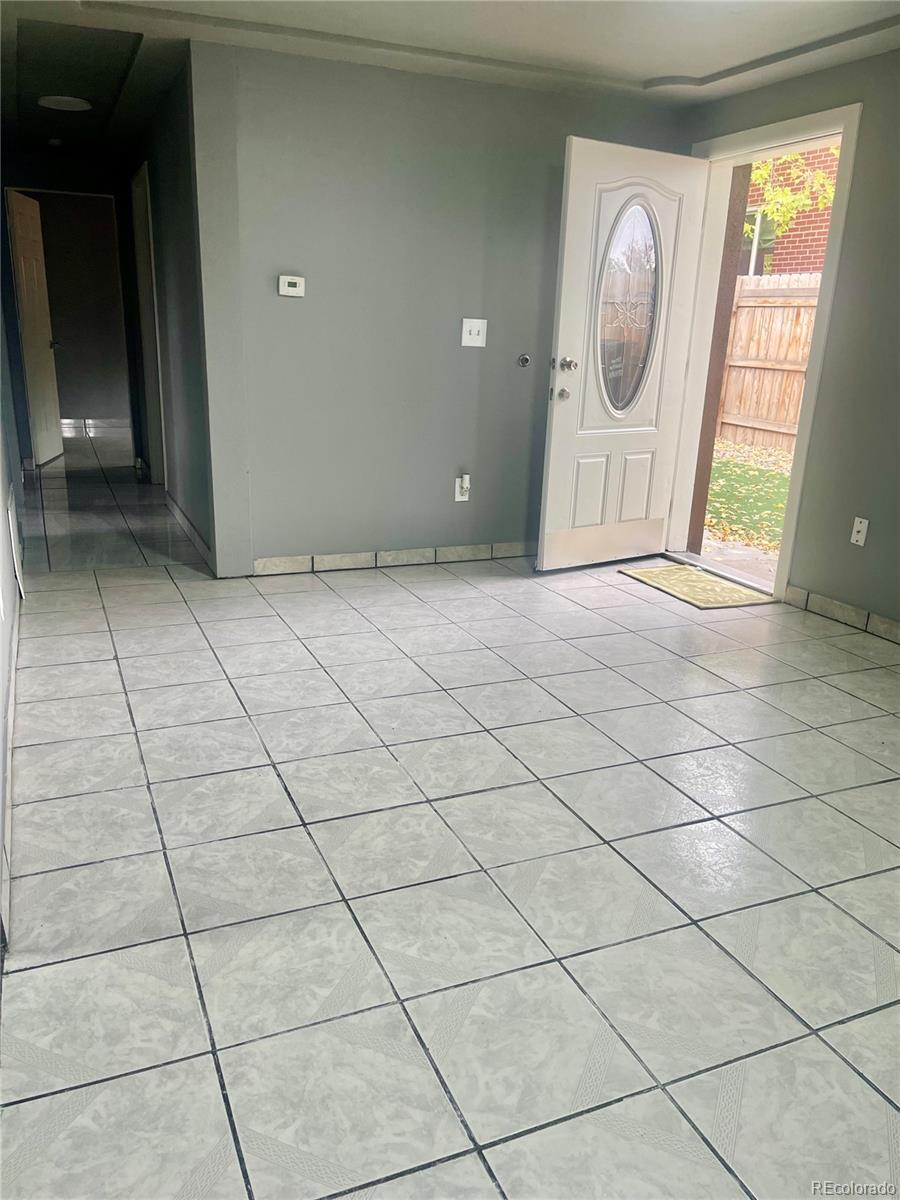 4332 West Nevada Place Denver, CO 80219 - Photo 6 of 14 a view of a livingroom with a washer and dryer