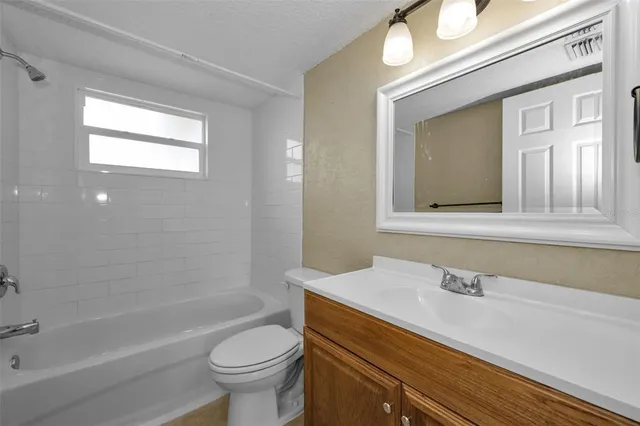 a bathroom with a sink a toilet and a bathtub