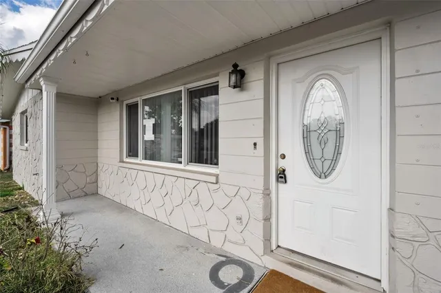 a front view of a house with white walls
