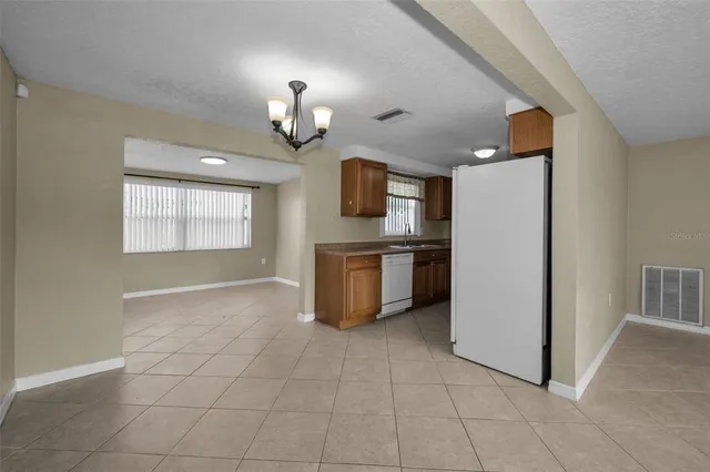 a kitchen with granite countertop a refrigerator and a stove