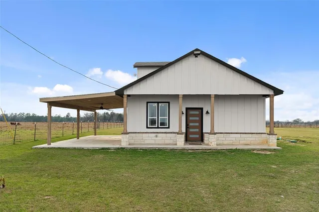 a front view of house with yard and outdoor seating