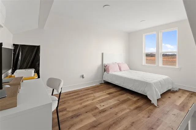 a bed sitting in a bedroom next to a window