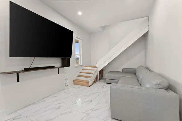 a living room with furniture and stairs