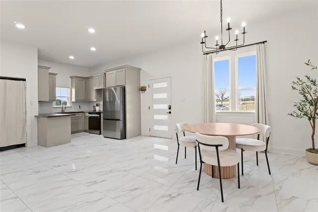 a kitchen with a refrigerator and a sink