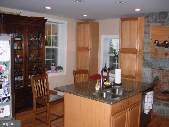 4415 Valley View Road Middletown, MD 21769 - Photo 5 of 16 a kitchen with a dining table chairs and refrigerator