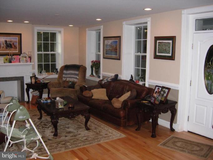 4415 Valley View Road Middletown, MD 21769 - Photo 8 of 16 a living room with furniture a large window and wooden floor