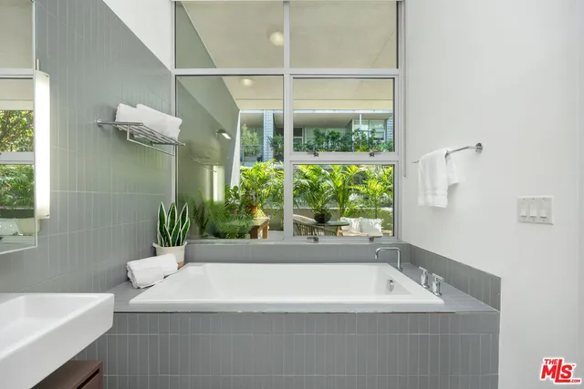 a white bath tub sitting next to a white sink