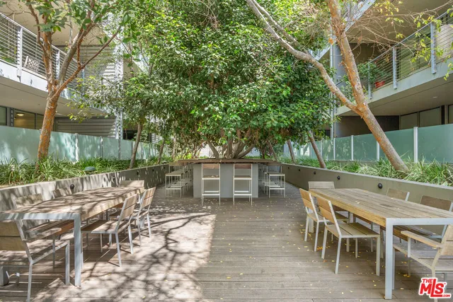 a view of a chairs and table in backyard of the house