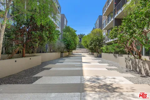 a view of a patio with a bench and trees