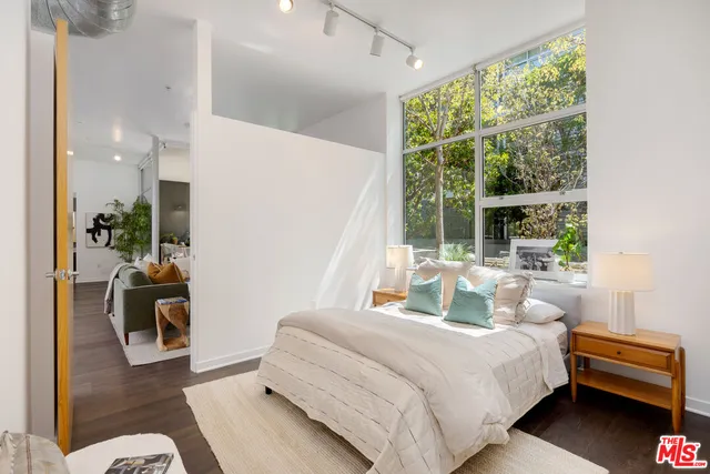 a bedroom with a bed and a couch