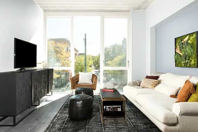 a living room with furniture tv and a window