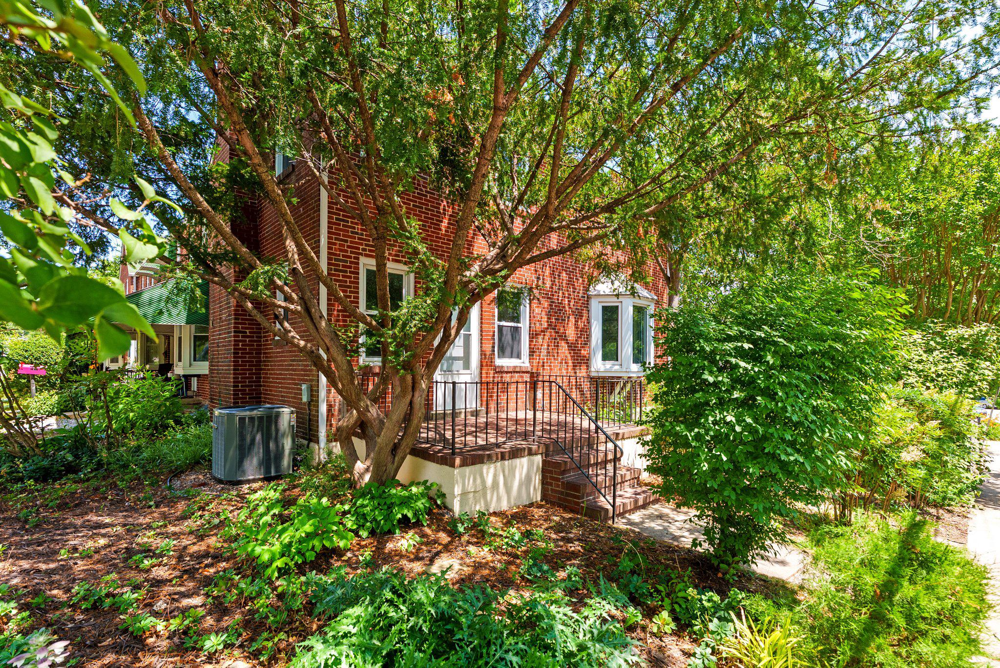 8401 Pleasant Plains Road Baltimore, MD 21286 - Photo 1 of 30 Charming end of group home with lush greenery.