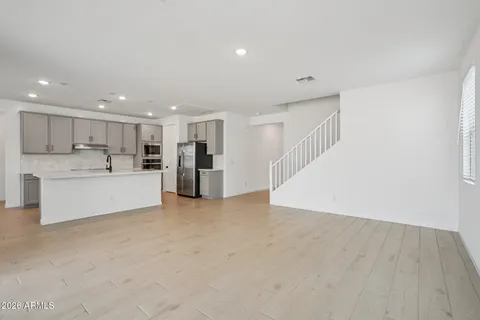 a kitchen with stainless steel appliances a refrigerator sink and microwave
