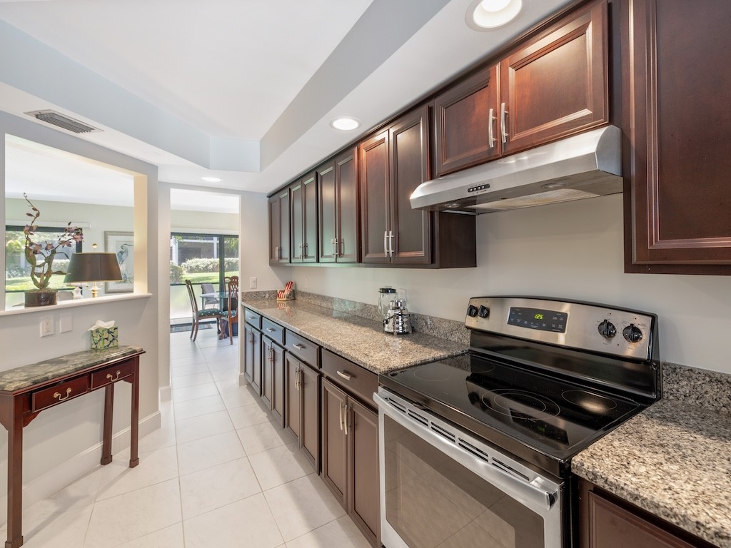 1155 Reef Road, Unit B7 Vero Beach, FL 32963 - Photo 11 of 31 a kitchen with a stove a sink and a refrigerator