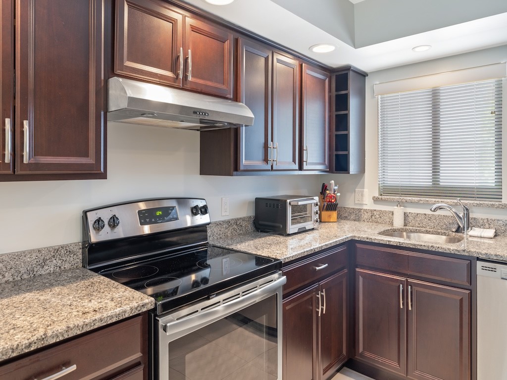 1155 Reef Road, Unit B7 Vero Beach, FL 32963 - Photo 13 of 31 a kitchen with a sink stove and cabinets