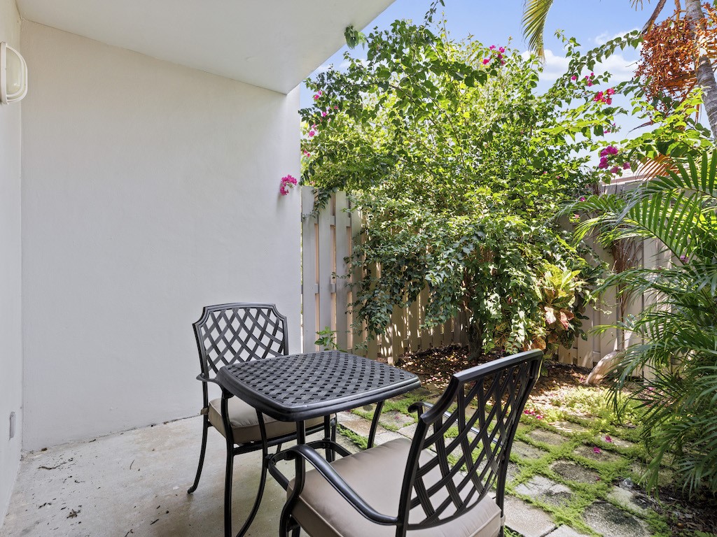 1155 Reef Road, Unit B7 Vero Beach, FL 32963 - Photo 16 of 31 a patio with a table and chairs and potted plants