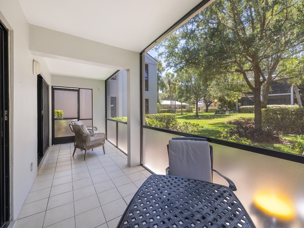 1155 Reef Road, Unit B7 Vero Beach, FL 32963 - Photo 24 of 31 a view of a porch with furniture and garden