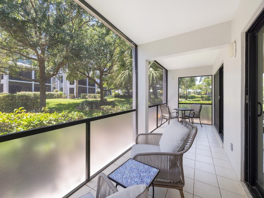 1155 Reef Road, Unit B7 Vero Beach, FL 32963 - Photo 25 of 31 a dining room with furniture and a floor to ceiling window
