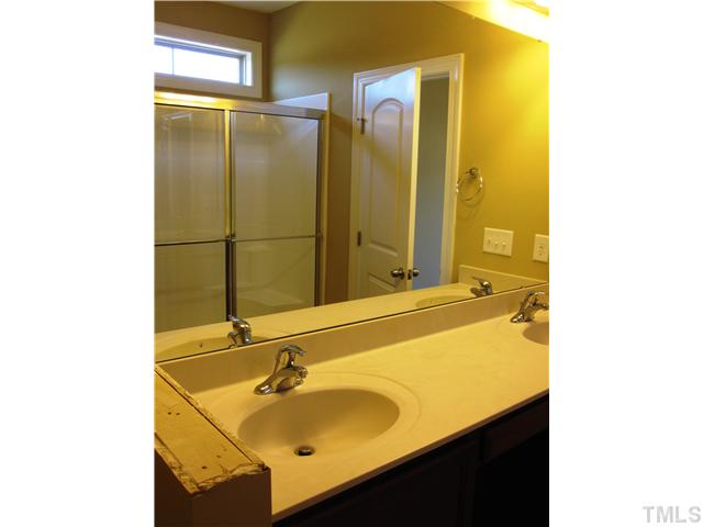 7639 Birchmoor Way, Unit LT91 Raleigh, NC 27616 - Photo 15 of 15 a bathroom with a sink and a mirror