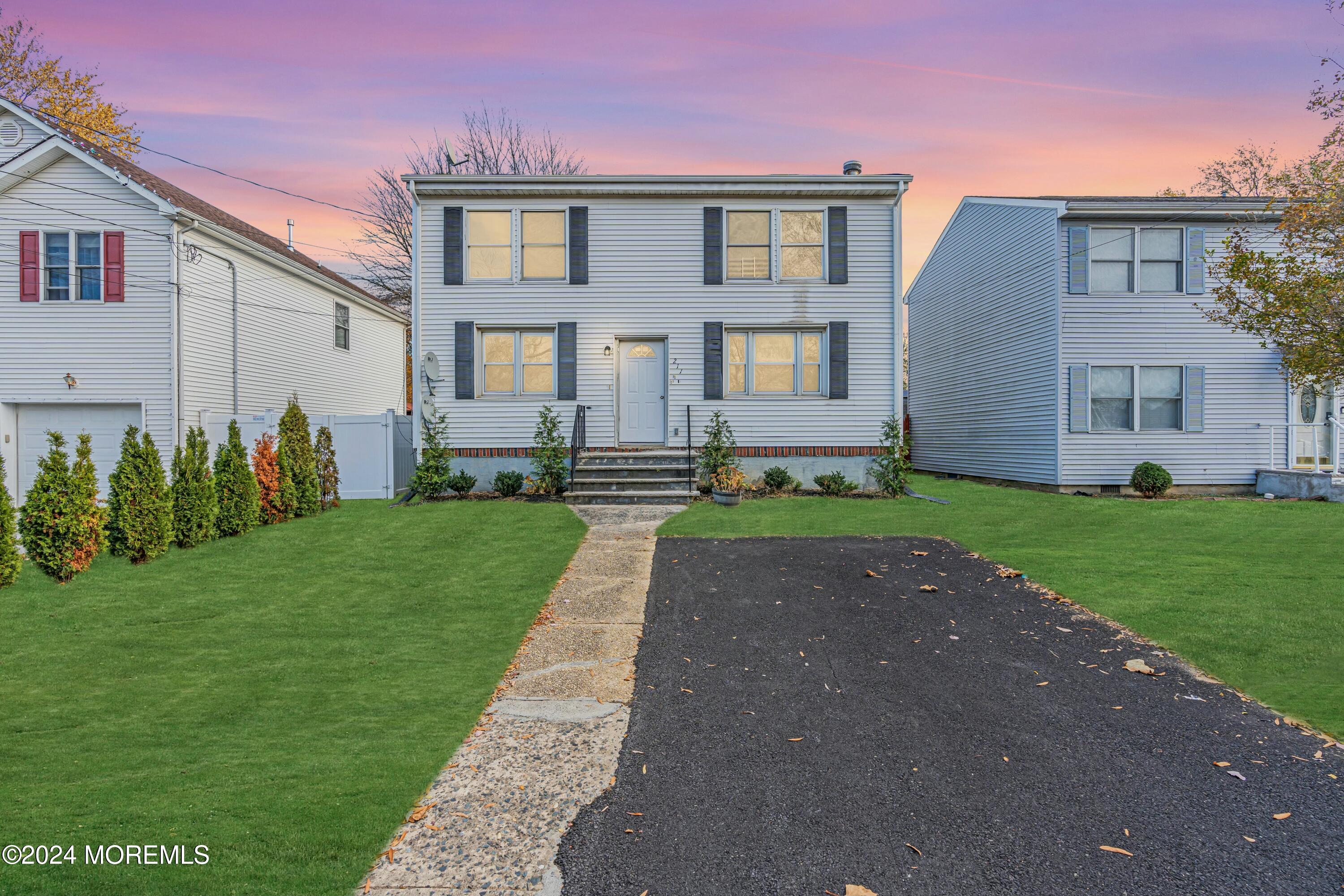211 Delaware Avenue, Unit 2 Cliffwood, NJ 07721 - Photo 1 of 16 a front view of a house with a yard