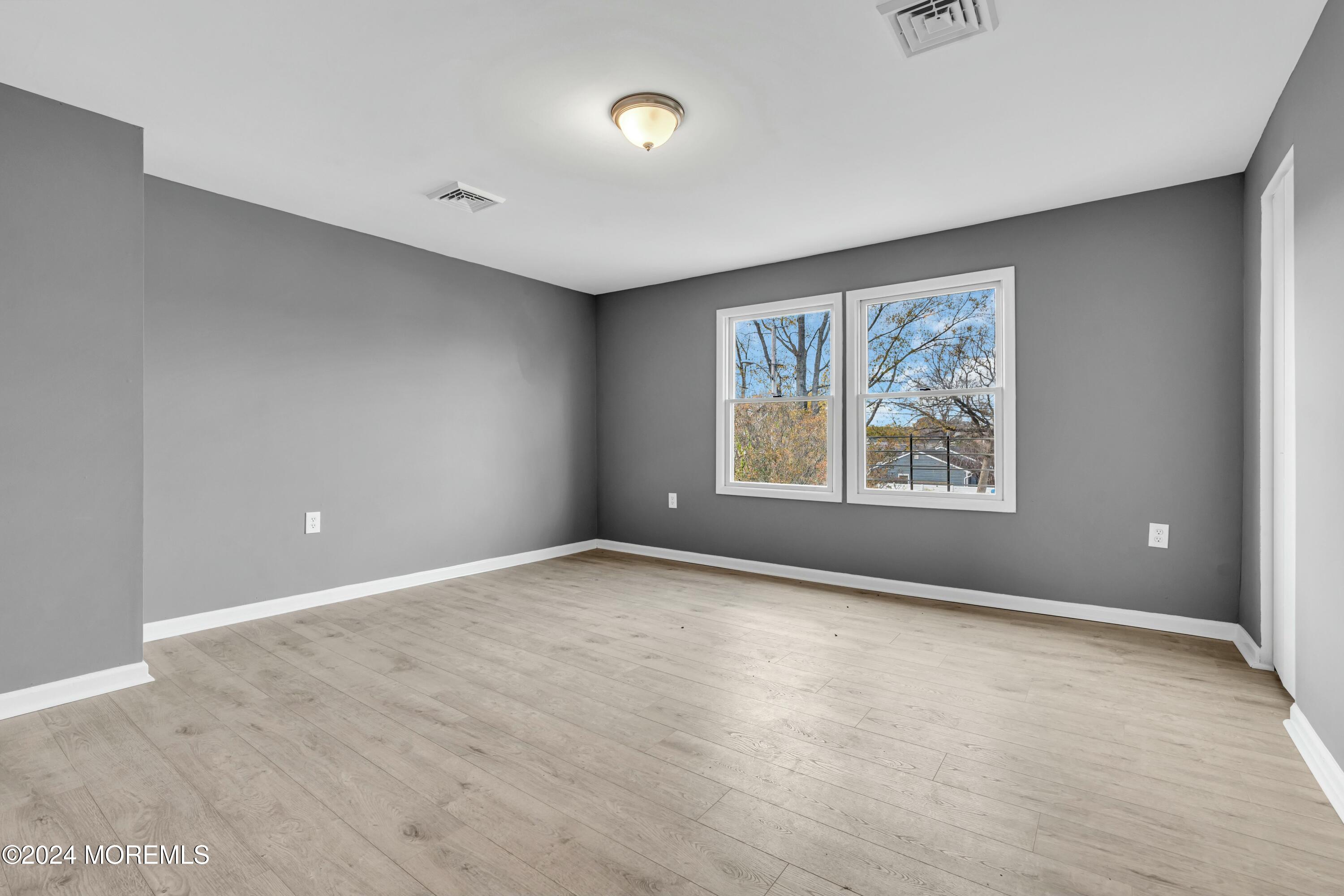 211 Delaware Avenue, Unit 2 Cliffwood, NJ 07721 - Photo 11 of 16 an empty room with windows
